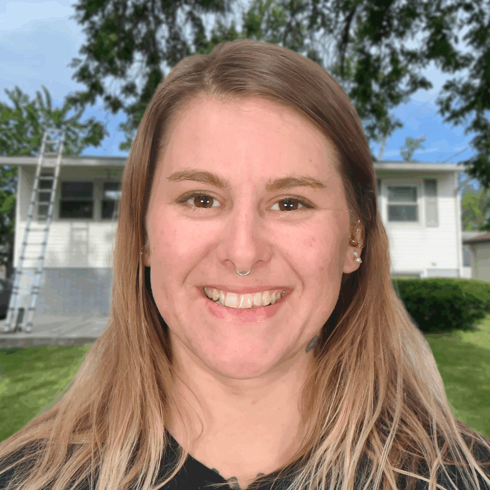 Smiling person in front of a house and a ladder, representing Omaha roofing services.