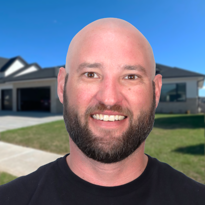 Smiling person in front of a house with a new roofing installation.