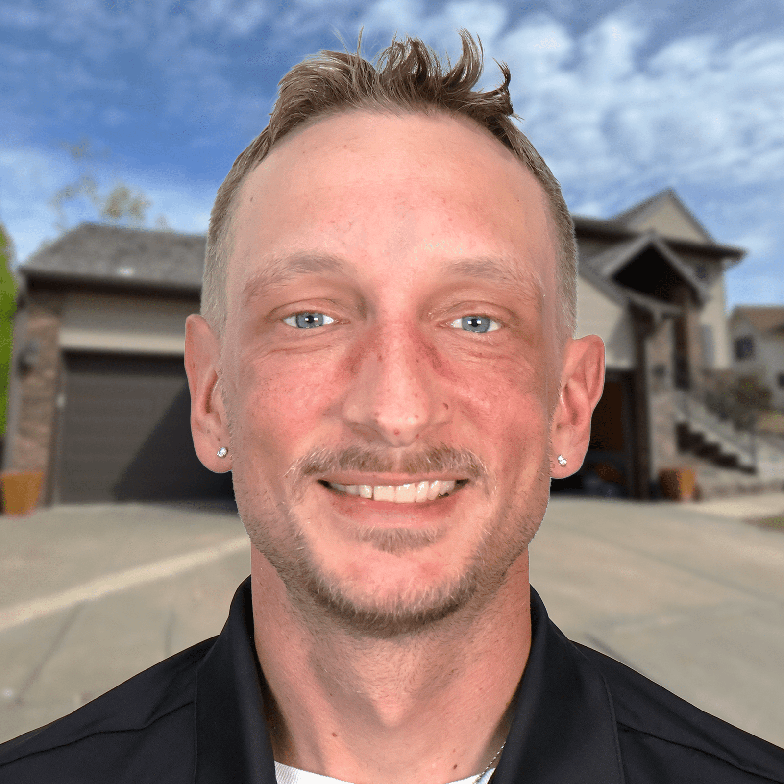 Smiling professional standing in front of a modern Omaha home with new roofing.